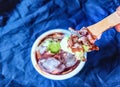 photo of a person using a small wooden stick to eat ice cream Royalty Free Stock Photo