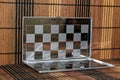 Photo with a picture of a steel chess Board. Metal board with reflection