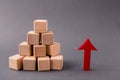 Photo of pile stack wooden cubes market supply sales growing rising raising red arrow pointing up income money progress Royalty Free Stock Photo