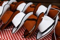 This is a photo of a pile of traditional Bavarian hats in white and brown colors Royalty Free Stock Photo