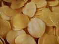 Photo of a pile of yellow shrimp crackers at a vegetable stall in a traditional market in Indonesia