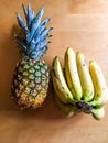 Photo of pineapple and bunch of bananas on the table Royalty Free Stock Photo