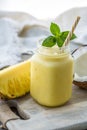 Photo of pineapple smoothie in jar with straw on light background. Fresh organic Smoothie. Health or detox diet food Royalty Free Stock Photo