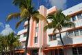 A photo of a pink and white building with palm trees in front, creating a colorful and tropical setting, An Art Deco hotel in Royalty Free Stock Photo