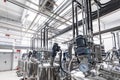 Photo of pipes and tanks. Chemistry and medicine production. Pharmaceutical plant. Interior of a high-tech factory Royalty Free Stock Photo