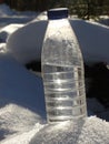 Plastic bottle of water in the snow Royalty Free Stock Photo