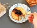 Photo of a plate of pancakes with a hand holding a fork Royalty Free Stock Photo