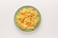 A photo of a plate of smoked salmon with bowtie pasta. Farfalle with salmon and a cream sauce, shot from above on a