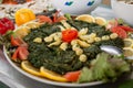 photo of a plate with stewed spinach on the buffet, Moroccan cuisine