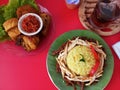 photo of a plate of yellow rice complete with side dishes