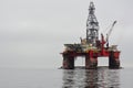 Photo of the platform oil rig placed in the ocean water on the right of the frame. On the left is a place for an inscription. Royalty Free Stock Photo