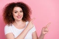 Photo of pleasant woman with perming coiffure dressed white t-shirt directing at proposition empty space isolated on Royalty Free Stock Photo