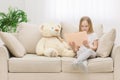 Photo of plush teddy bear and little girl holding a book. Royalty Free Stock Photo