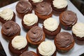 Photo porcelain dishes with 16 muffins with white chocolate spirals cream