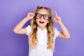 Photo portrait of adorable excited small girl tails eureka finger point up wear stylish white uniform on violet