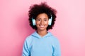 Photo portrait of adorable small girl headphones listening music playlist smile wear trendy blue outfit isolated on pink Royalty Free Stock Photo