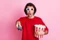 Photo portrait of amazed man with popcorn watching blockbuster using console wearing 3d glasses isolated on pastel pink Royalty Free Stock Photo