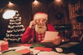 Photo portrait amazed santa with white beard wearing glasses reading wishlist before xmas