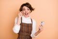 Photo portrait of amazed schoolgirl in spectacles browsing internet opened mouth isolated on pastel beige color