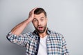 Photo portrait of amazed shocked man keeping head opened mouth isolated on grey color background