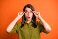 Photo portrait of amazed stressed female freelancer touching glasses opened mouth staring isolated on vibrant orange