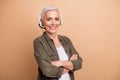 Photo portrait of attractive retired woman crossed hands headset hot line dressed stylish khaki clothes isolated on Royalty Free Stock Photo