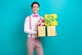 Photo portrait of attractive young man hold pile presents boxes celebration wear trendy pink clothes isolated on cyan