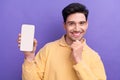 Photo portrait of attractive young man hold white screen device dressed stylish yellow clothes isolated on purple color Royalty Free Stock Photo