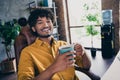 Photo portrait of attractive young man wear yellow shirt working break pause coffee mug modern workplace room home