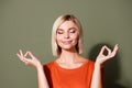 Photo portrait of attractive young woman closed eyes meditate dressed stylish orange clothes isolated on khaki color Royalty Free Stock Photo