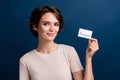 Photo portrait of attractive young woman hold credit card pay cashless dressed stylish white clothes isolated on dark Royalty Free Stock Photo