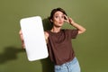 Photo portrait of attractive young woman hold device screen v-sign kiss dressed stylish brown clothes isolated on khaki