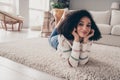 Photo portrait of attractive young woman lying floor enjoy comfort dressed casual clothes cozy day light home interior Royalty Free Stock Photo