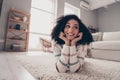 Photo portrait of attractive young woman lying floor look empty space dressed casual clothes cozy day light home Royalty Free Stock Photo