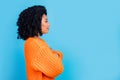 Photo portrait of attractive young woman profile crossed hands dressed stylish knitted orange clothes isolated on blue