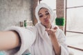 Photo portrait of attractive young woman selfie photo send you air kiss head wrapped towel dressed bath robe home Royalty Free Stock Photo