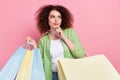 Photo portrait of attractive young woman shopping bags look minded empty space wear trendy green clothes isolated on Royalty Free Stock Photo