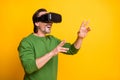 Photo portrait of bearded man playing game virtual reality wearing glasses smiling isolated on vivid yellow color