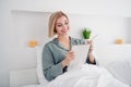 Photo portrait of blonde attractive young woman sit bed to do list note dressed stylish gray pajama light modern bedroom