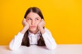 Photo portrait bored schoolgirl looking copyspace wearing shirt isolated bright yellow color background Royalty Free Stock Photo