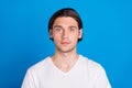 Photo portrait brunet man serious wearing white t-shirt isolated vivid blue color background