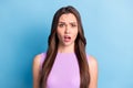 Photo portrait of brunette girl with clueless misunderstanding face long straight hair isolated on vivid blue color Royalty Free Stock Photo