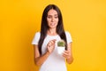 Photo portrait brunette keeping cactus plant in white pot touching long pins  on vibrant yellow color background Royalty Free Stock Photo