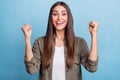 Photo portrait brunette woman gesturing like winner smiling isolated pastel blue color background Royalty Free Stock Photo