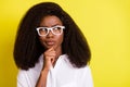 Photo portrait of business woman wearing glasses thoughtful touching chin looking copyspace isolated vibrant yellow Royalty Free Stock Photo