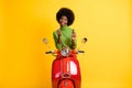 Photo portrait of casual black skinned brunette woman bike driver applying red lip gloss with brush isolated on vivid Royalty Free Stock Photo