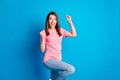 Photo portrait of cheerful brunette girl gesturing like winner smiling isolated on vivid blue color background