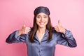 Photo portrait of cheerful girl showing two thumbs up isolated on pastel pink colored background Royalty Free Stock Photo