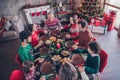 Photo portrait couples grandparents little children praying together on xmas holding hands at table before dinner in