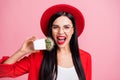 Photo portrait of crazy girl biting cactus isolated on pastel pink colored background Royalty Free Stock Photo